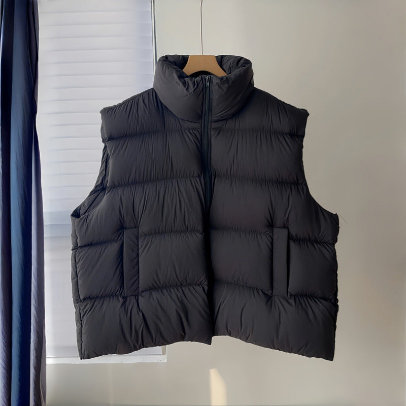 black vest on hanger: Women's Plus Size Black Puffer Vest Front View With Stand Collar, Zip Closure And Side Pockets