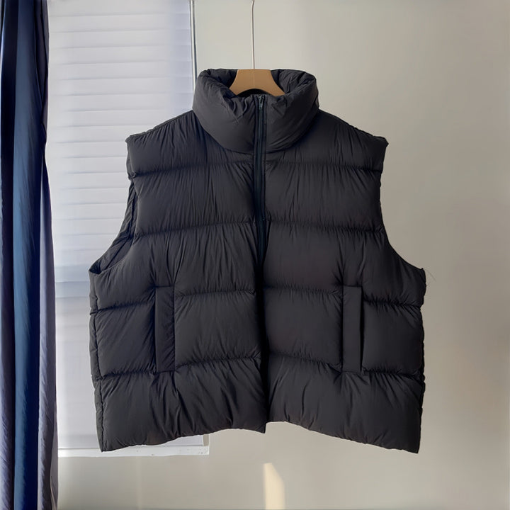 black vest on hanger: Women's Plus Size Black Puffer Vest Front View With Stand Collar, Zip Closure And Side Pockets