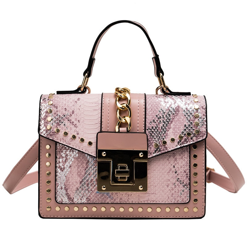 Pink snakeskin-texture handbag with stud trim, gold chain, and front flap gold-lock clasp