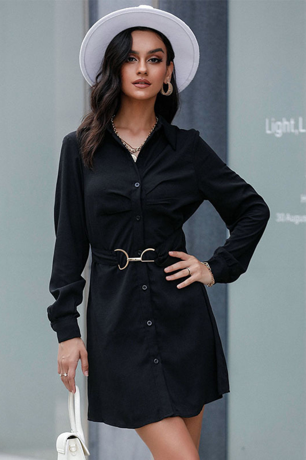 Black belted mini shirt dress with long sleeves, button front and V-neck