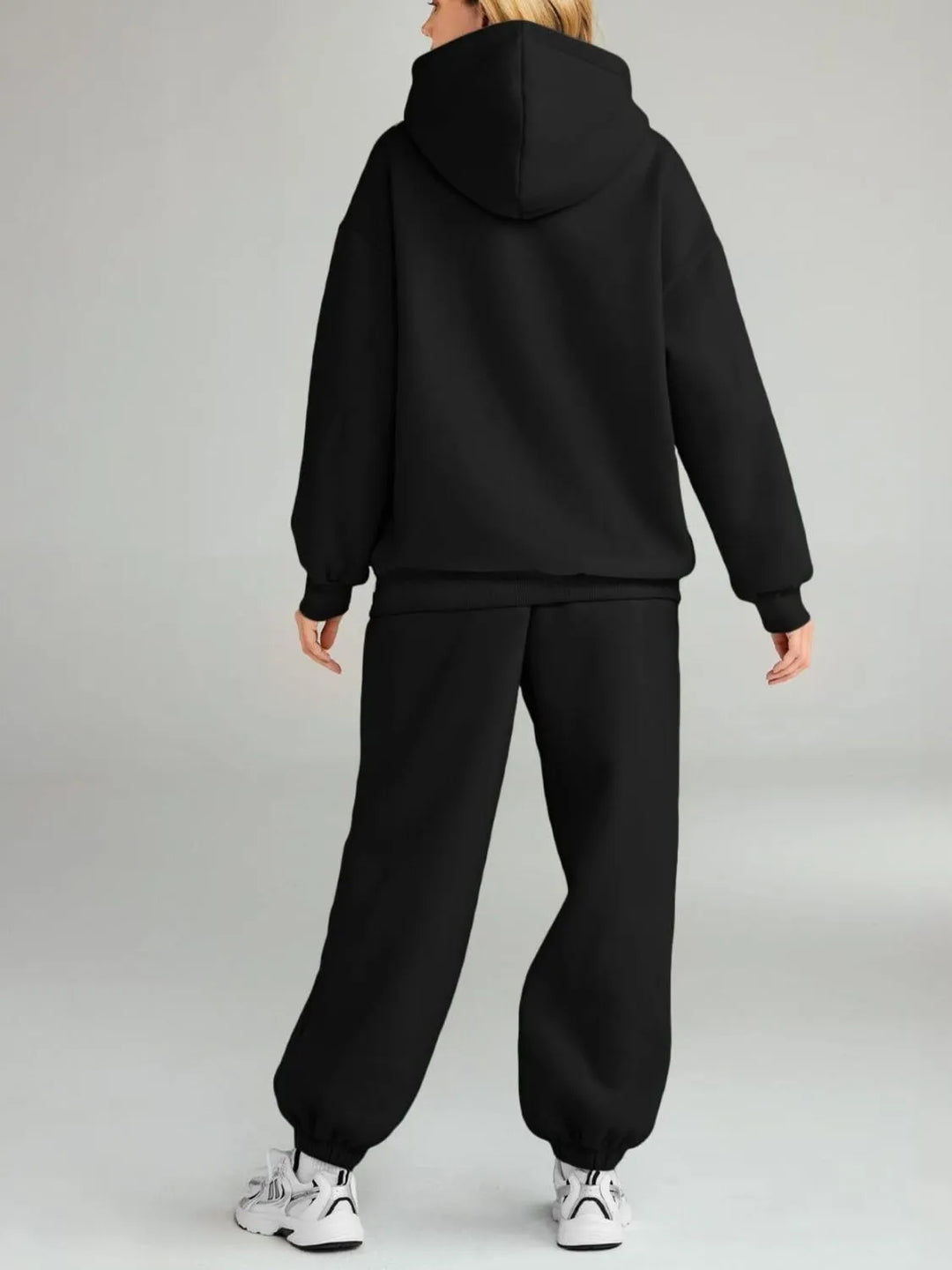 Back view of plus-size black hoodie and jogger set with hood and matching pants
