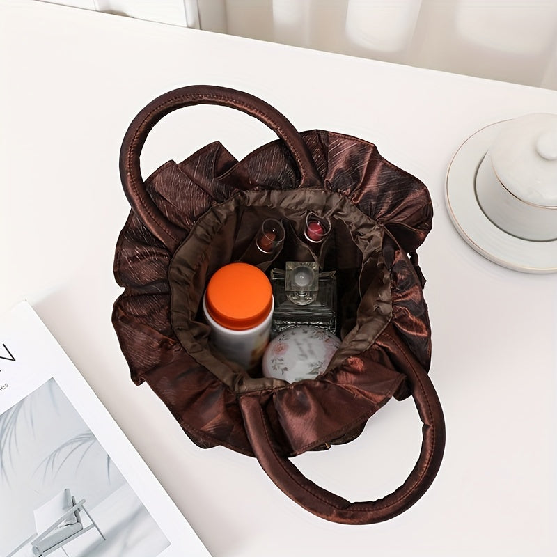 Brown drawstring bag with cosmetic items on a white surface