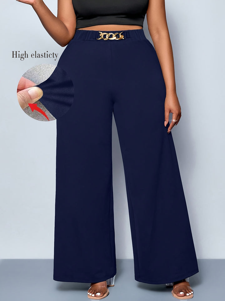 Navy blue wide-leg pants with a gold belt on a gray background