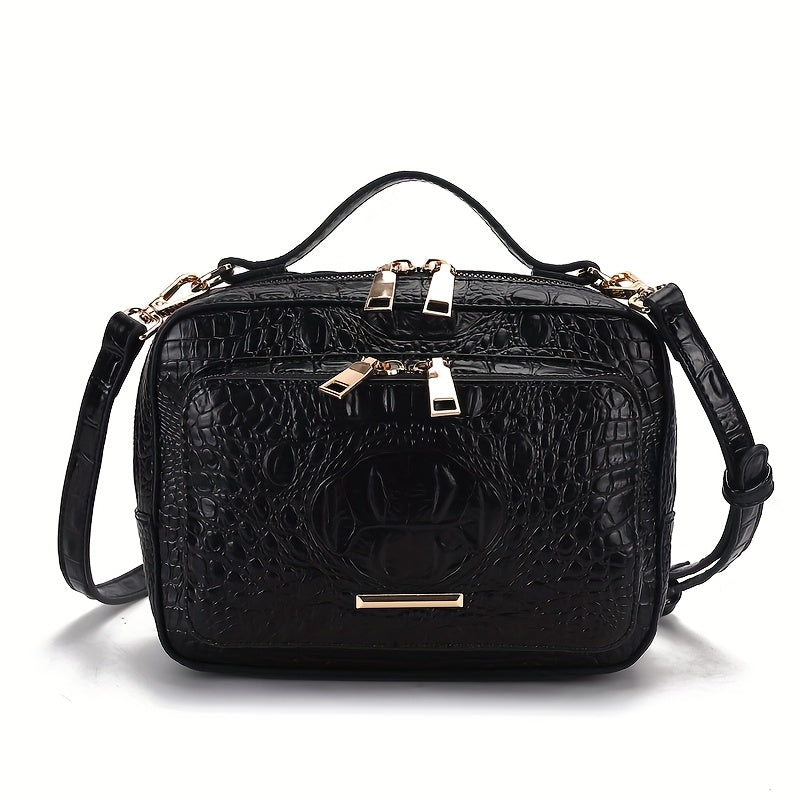 Black crocodile-patterned handbag with gold accents on a white background
