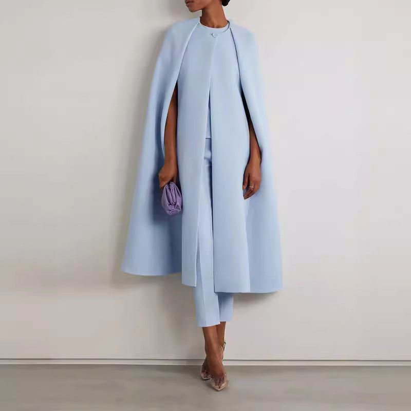 Person wearing a light blue coat and pants with a white background