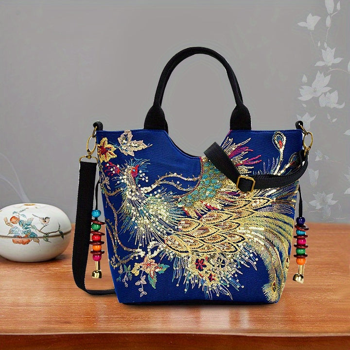 Decorative handbag with peacock design on a wooden surface