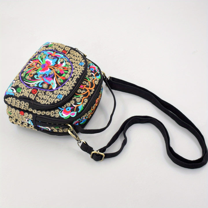 Decorative handbag with colorful patterns and a black strap on a white background