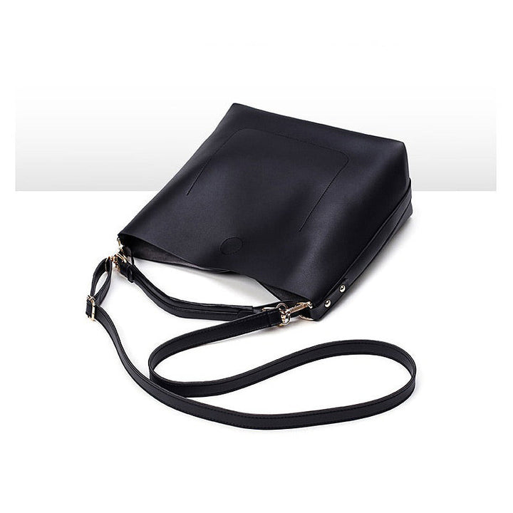 Black leather-look hobo crossbody bag with long strap and top fold-over opening