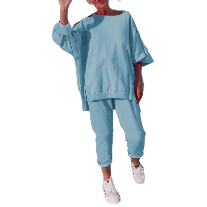 Person wearing a light blue outfit with white sneakers on a white background