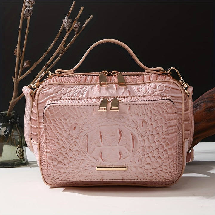 Pink textured handbag with gold accents on a white surface with a dark background