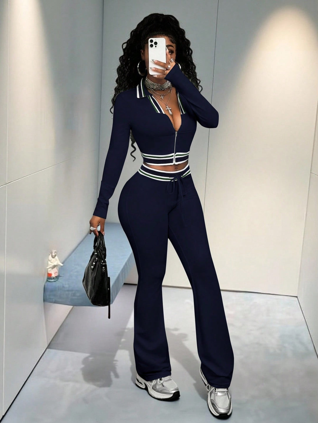Navy women’s high-neck zip crop top and slim track pants set with striped trim