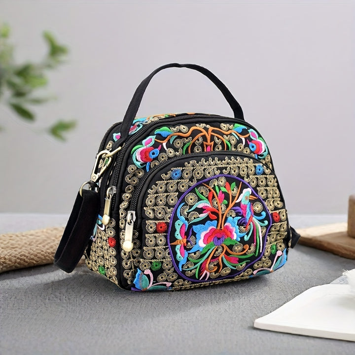 Colorful embroidered handbag on a gray surface with a light gray background