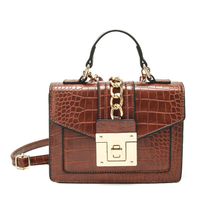 Brown crocodile-texture satchel with top handle, chain detail, front flap, and gold turn-lock clasp