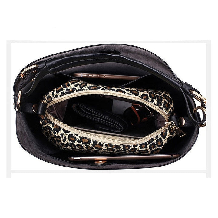 Black leather-look hobo bag open to reveal patterned interior zip pocket and lining