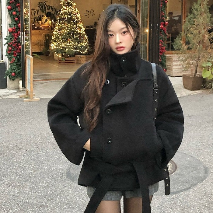 Black wool short coat with stand-up collar, double-breasted front, and wide belt