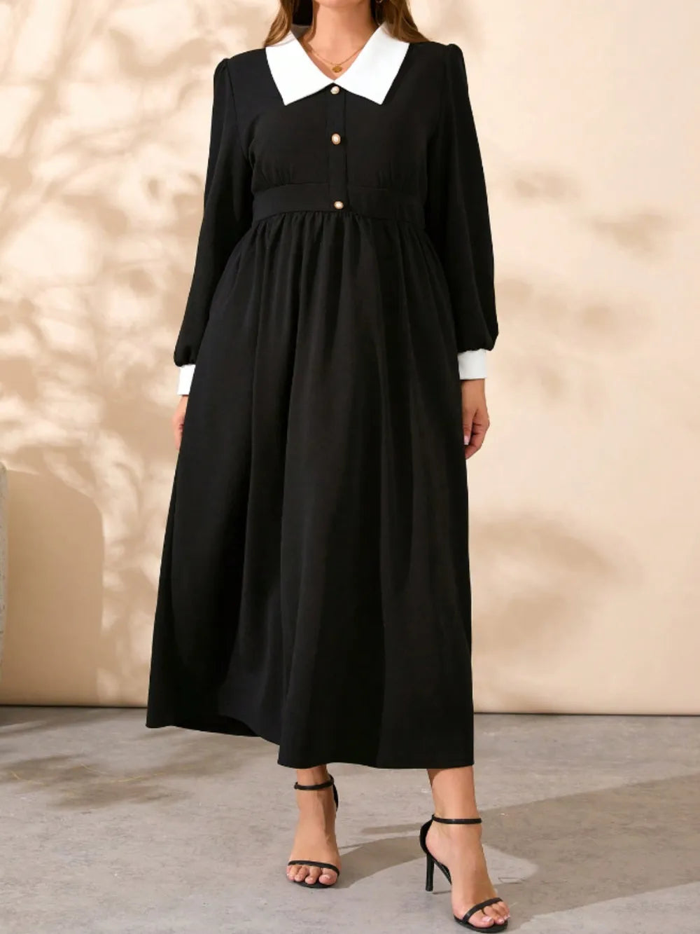 Black midi dress with contrast white collar, long sleeves, and gathered waist