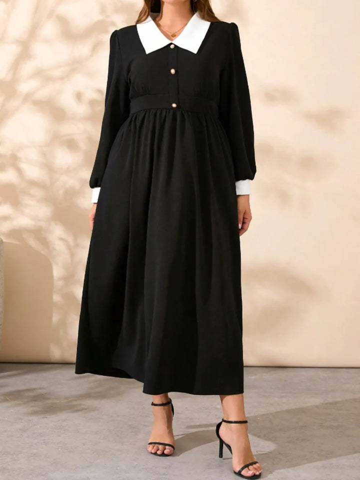 Black midi dress with contrast white collar, long sleeves, and gathered waist