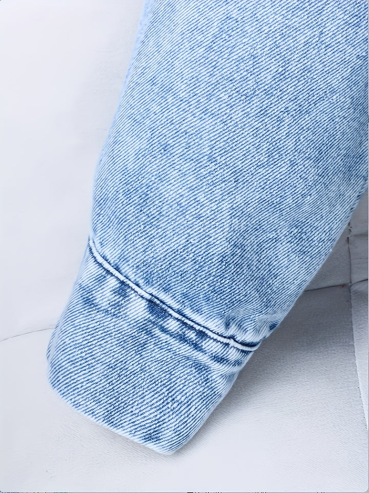 Close-up of a blue denim jacket on a light gray background
