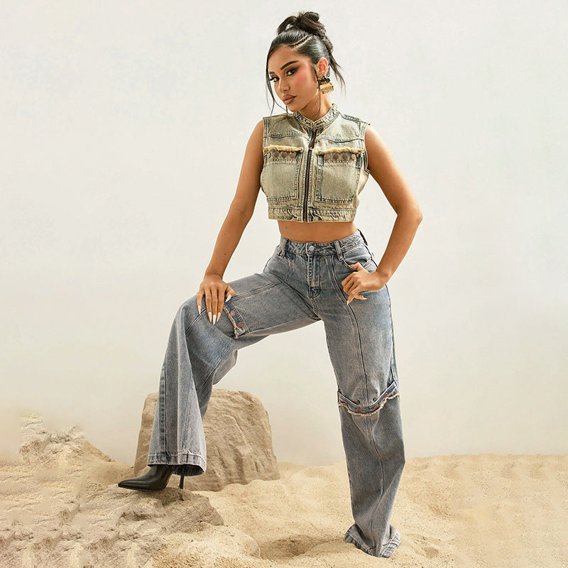Woman in a vest and jeans posing in a desert-like setting