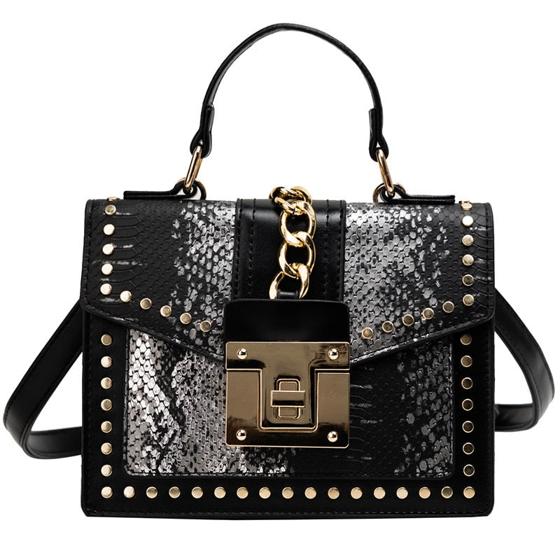 Alligator-texture handbag with chain strap, black and speckled panels, gold studs, flap lock