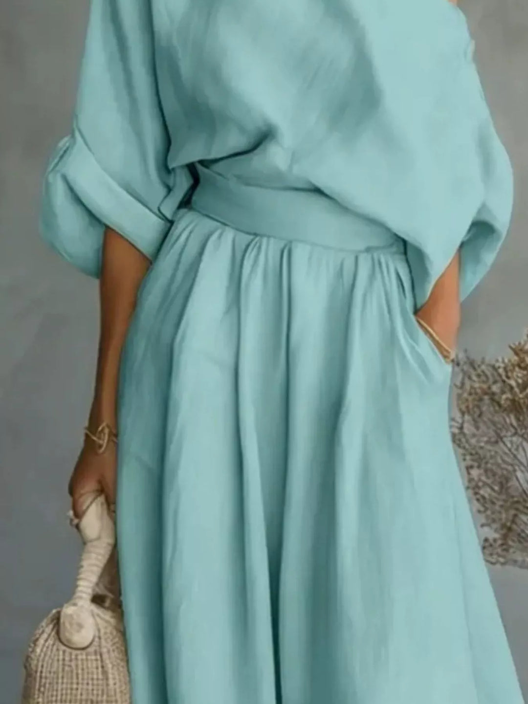 Teal one-shoulder top and wide-leg pants set with cinched gathered waist and flowy fabric