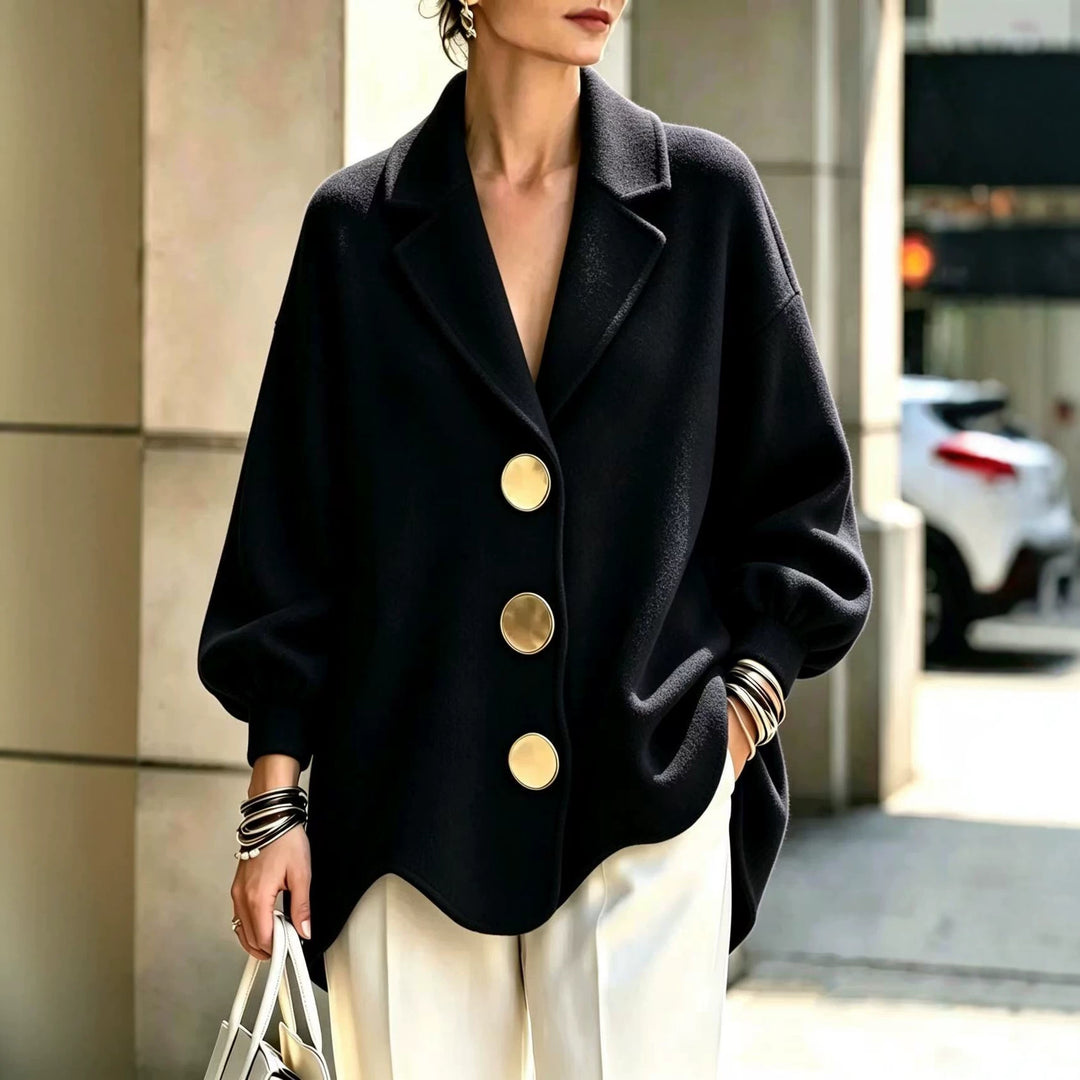 Women's Black V-Neck Statement-Button Blouse With Puff Sleeves, Styled With Cream Trousers Outdoors