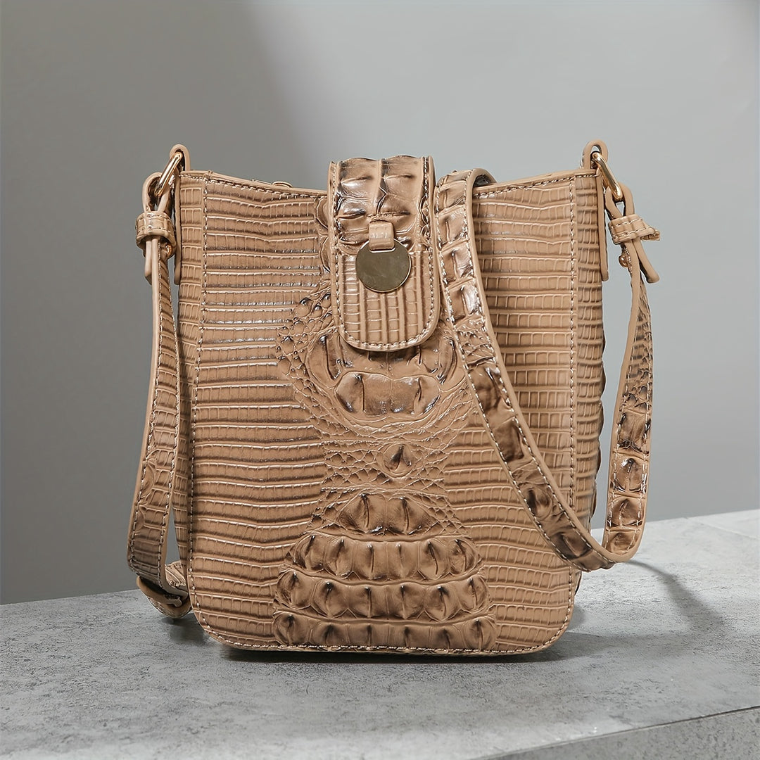 Beige textured handbag on a gray surface with a neutral background