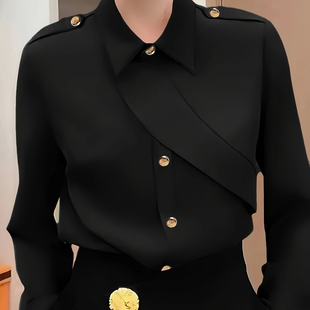 Black coat with gold buttons on a mannequin against a neutral background
