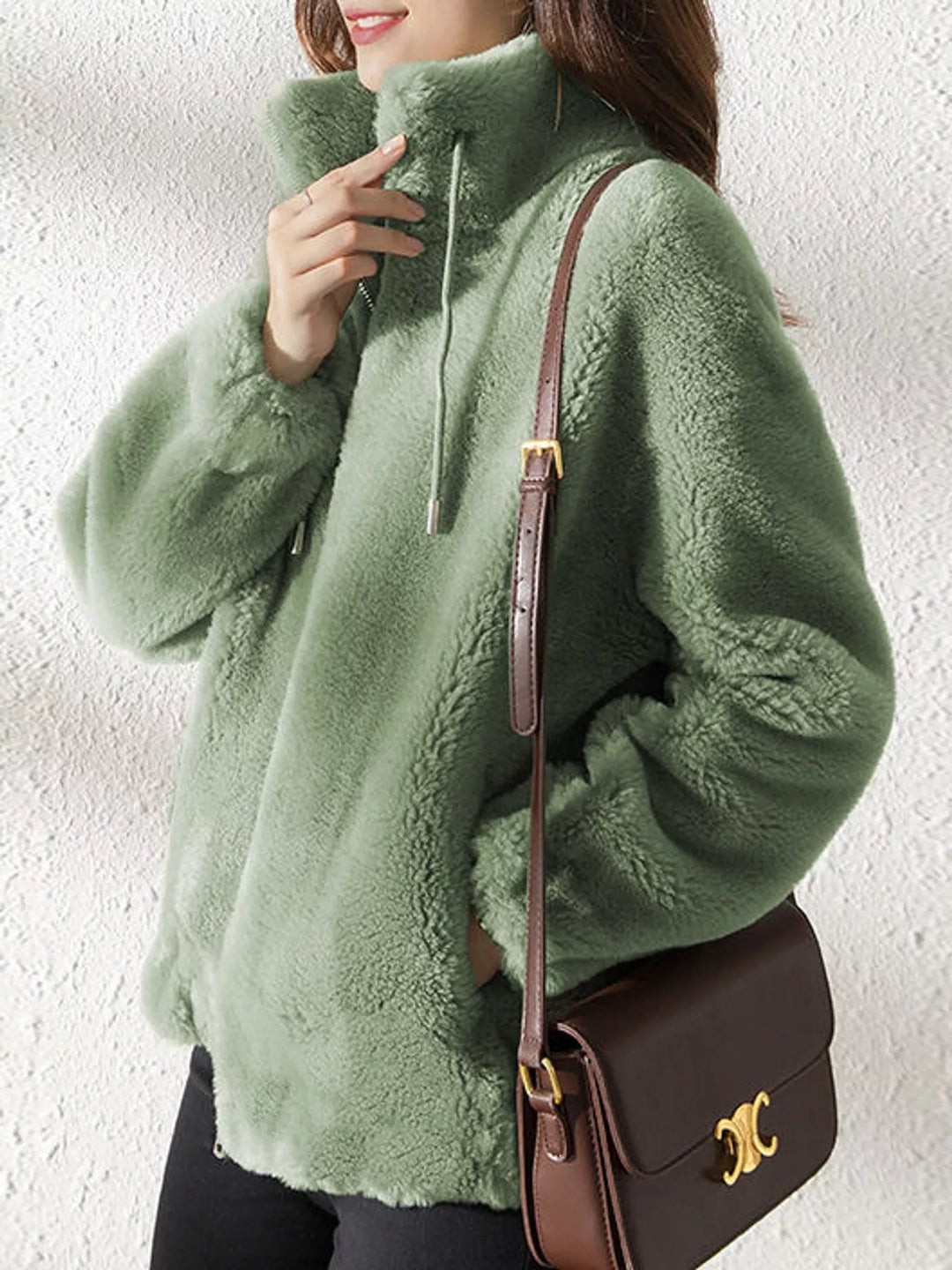 Green faux fur stand-collar zip jacket with drawstring ties, side view