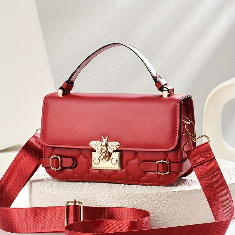 Red handbag with gold accents on a light background