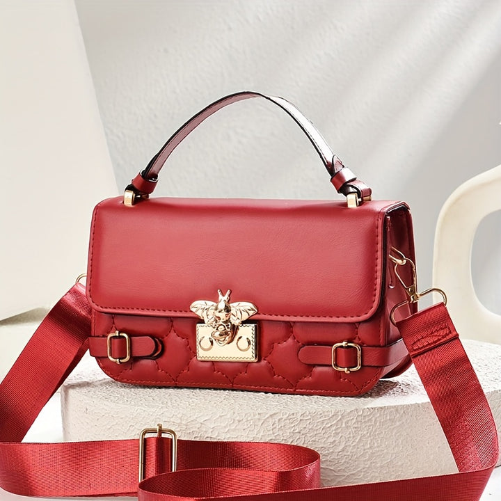 Red handbag with gold accents on a light background