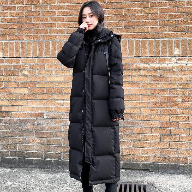 Women's Black Quilted Longline Coat With Hood And Long Sleeves, Full-Length Model View.