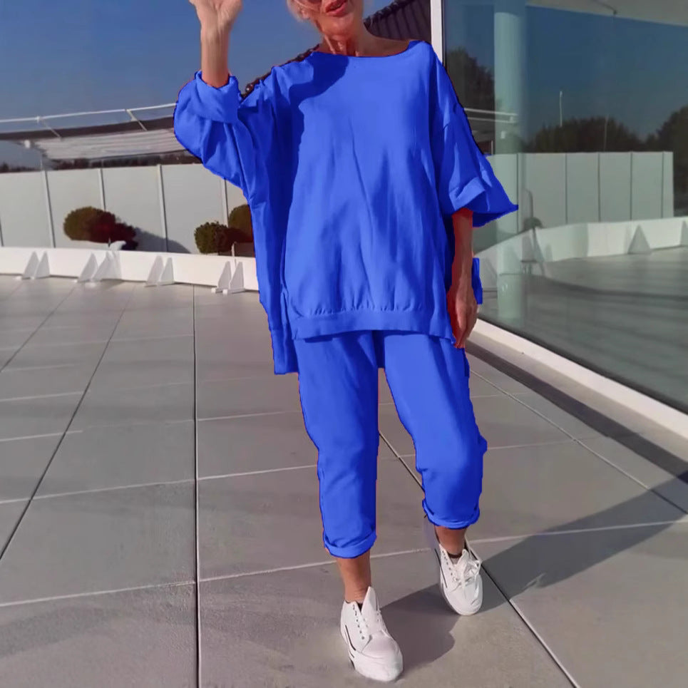 Person wearing a blue outfit on a rooftop with a modern building in the background