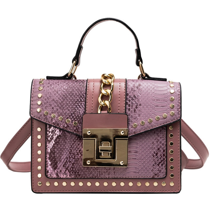 Alligator-texture handbag with chain strap, mauve/purple body, gold studs, front flap lock