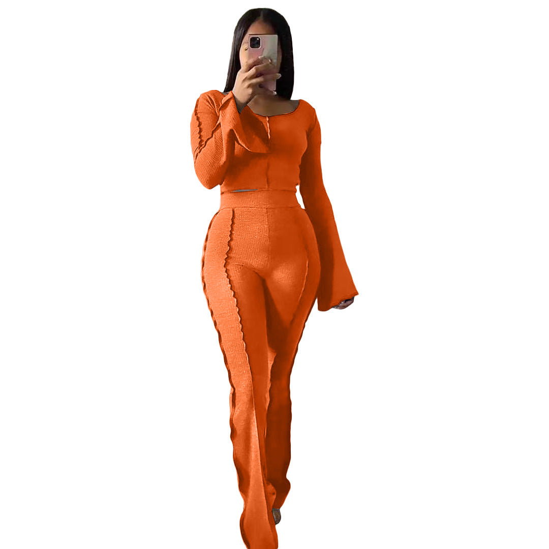Woman in house wearing snug-fit orange Yoga Sets