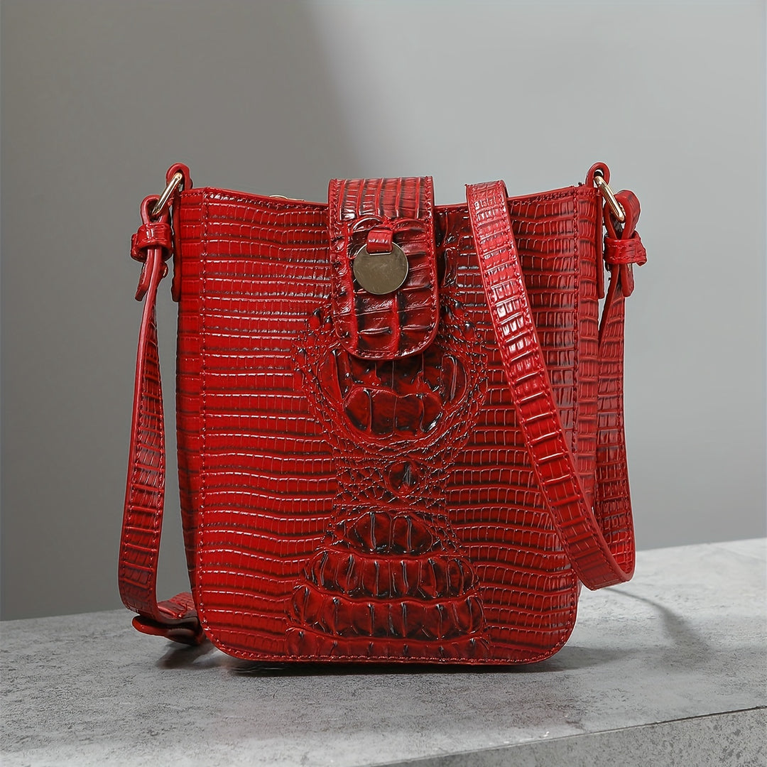 Red textured handbag on a gray surface with a neutral background