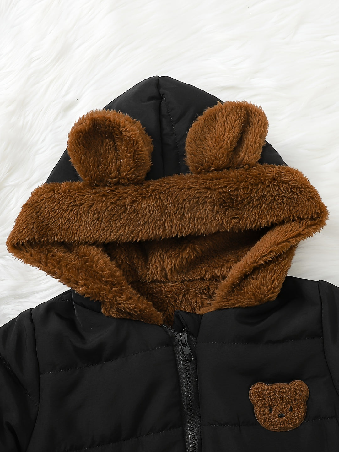 Black jacket with brown bear ears and face on a white background
