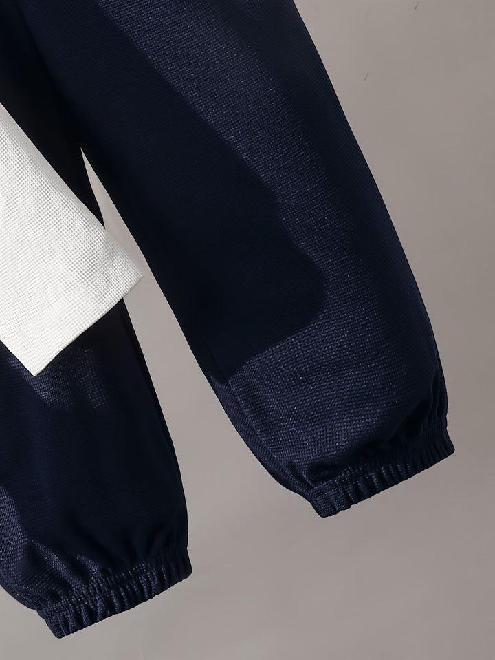 Navy blue pants with white geometric pattern on a gray background