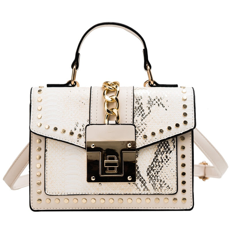 Alligator-texture handbag with chain strap, white body, gold studs, front flap lock