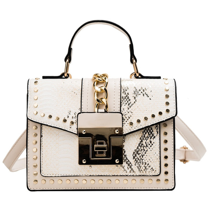 Alligator-texture handbag with chain strap, white body, gold studs, front flap lock