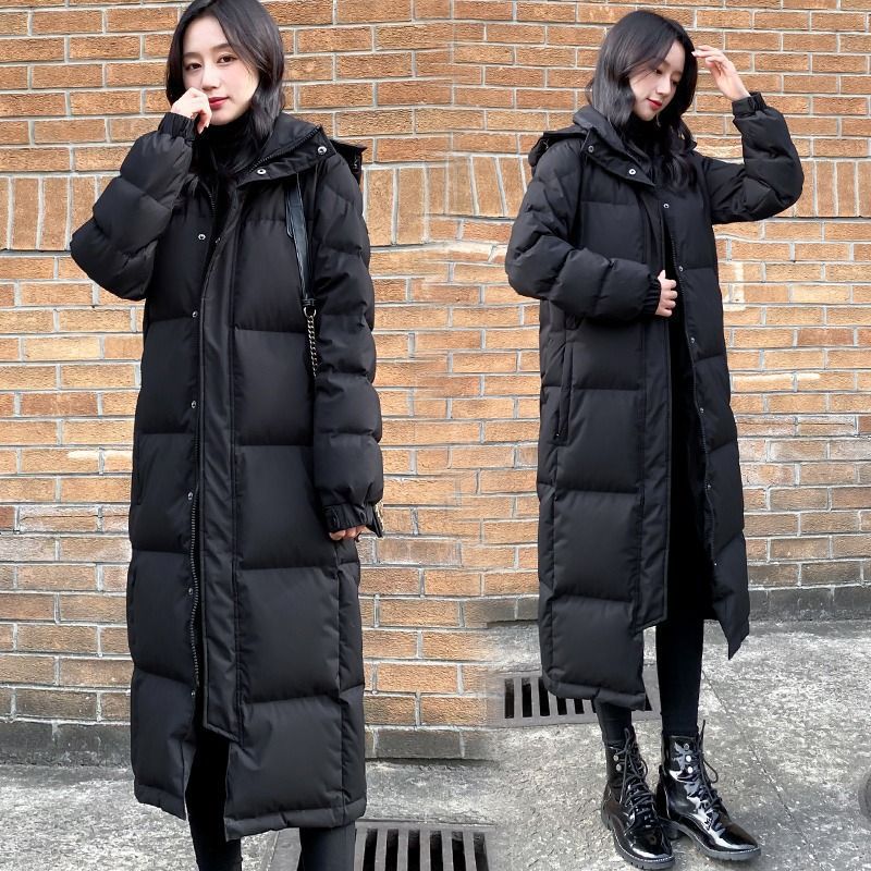 Women's Black Hooded Padded Coat Shown Open And Closed With Black Boots.