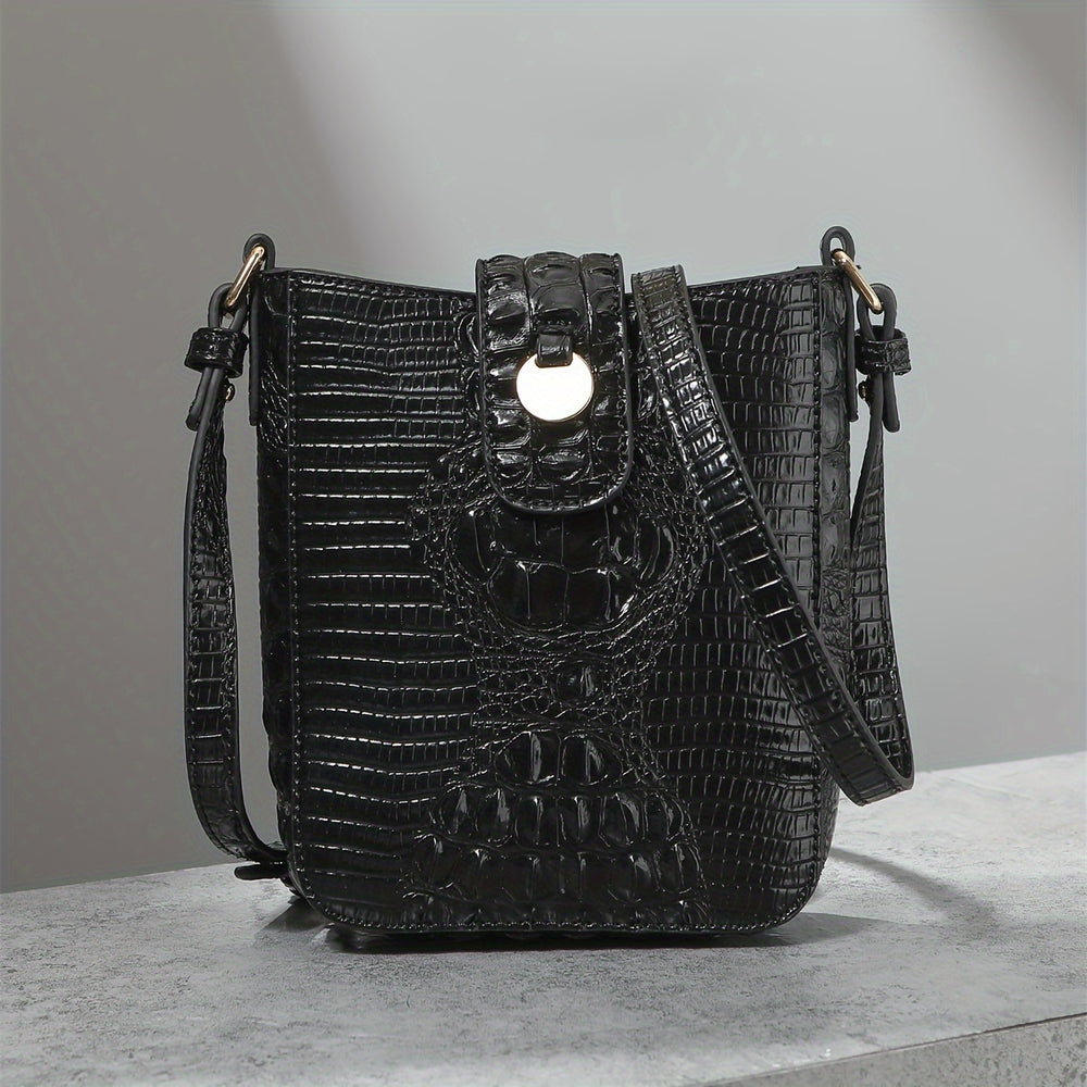 Black textured handbag on a gray surface with a neutral background