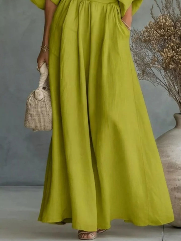 Lime green wide-leg pants and one-shoulder top set with pleated skirt-like drape