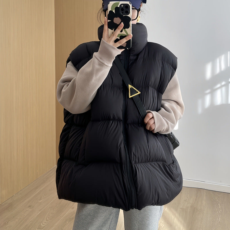 black vest worn: Women's Plus Size Black Quilted Puffer Vest With High Collar Styled Over A Beige Sweater