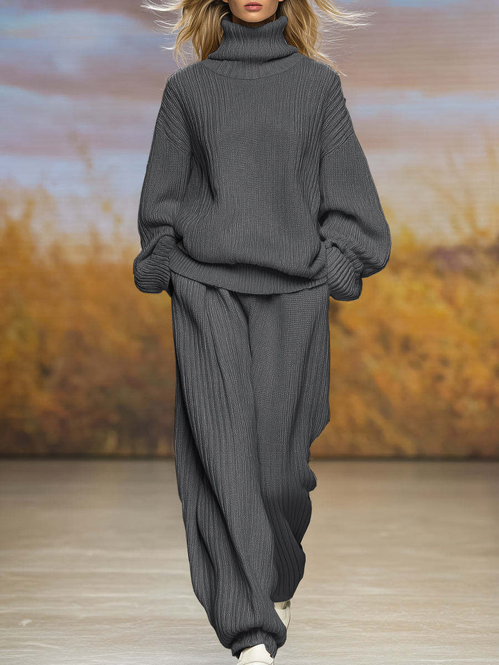 Dark gray ribbed knit two-piece set with high-neck top and wide-leg pants, long sleeves
