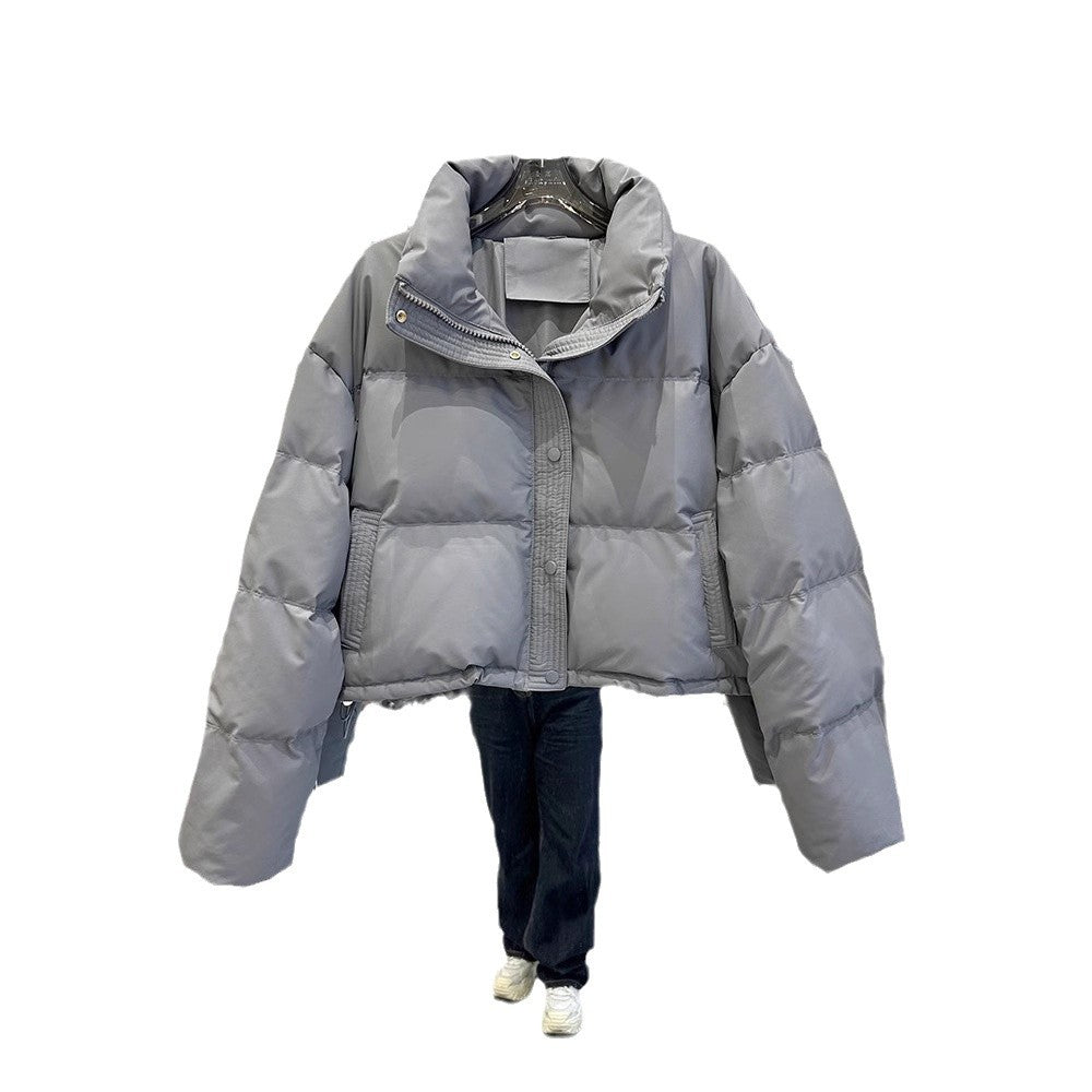 Light gray women's puffer down coat with high neck and front zip snap closure