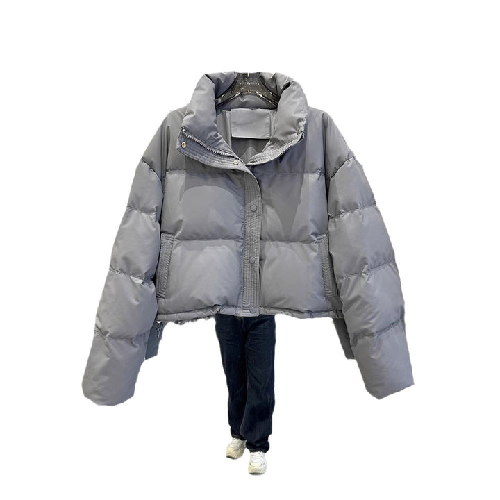 Light gray women's puffer down coat with high neck and front zip snap closure