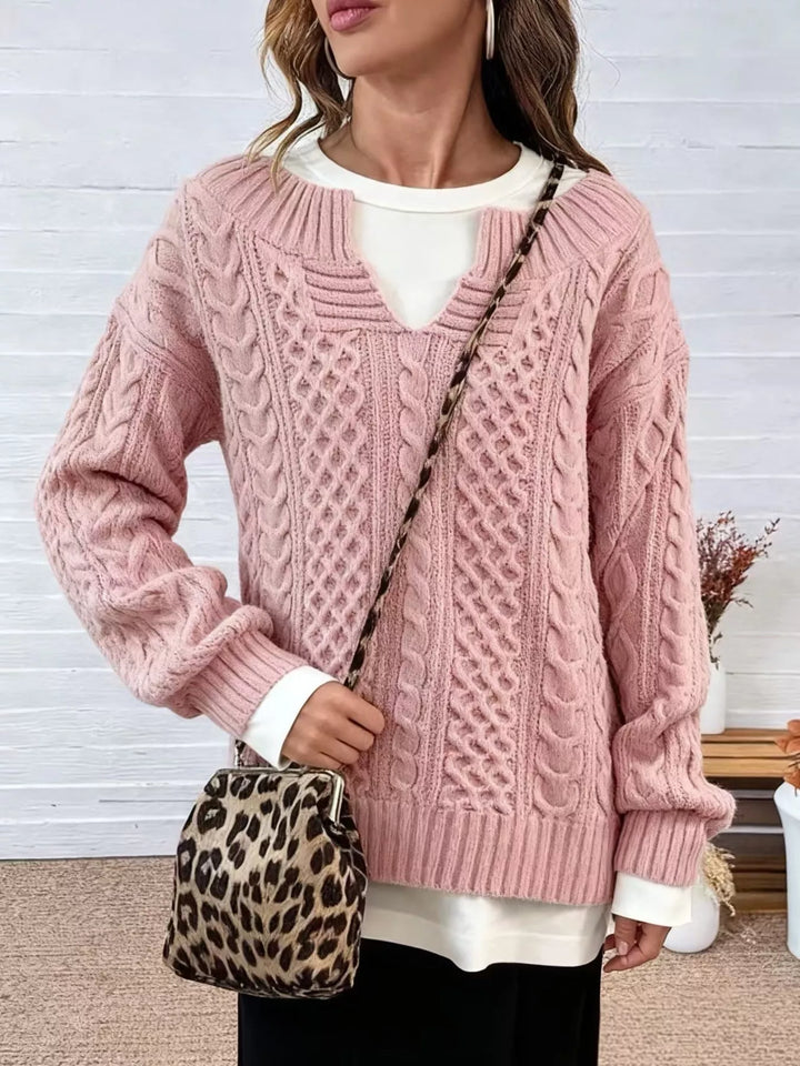Pink cable-knit V-neck sweater with dropped shoulders and ribbed cuffs