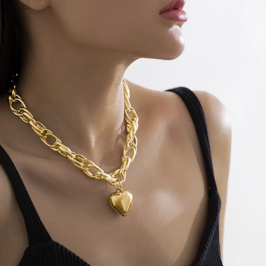 Women with thick chain necklace withlarge heart penant.