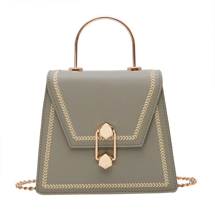 Sage green mini clutch handbag with gold metal handle, braided trim, and front clasp